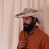 model wearing natural Fisherman Cruiser Hemp Hat side view, Hand-made in Nepal